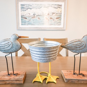 Admire charming coastal decor while enjoying delightful conversations around the inviting dining table