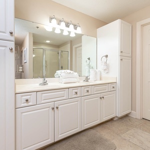 Experience this spacious master bathroom with a double vanity, ample storage, and plush towels for your comfort