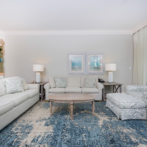 Relax on the plush seating in this family room, featuring a sofa with queen sleeper, and plenty of cozy options