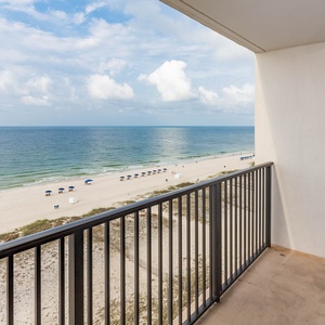 This balcony offers a stunning beach front view, perfect for relaxing with a refreshing drink in hand