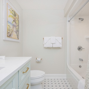 Enjoy a relaxing shower after a day of adventure in this guest bath with stylish accents and fluffy towels