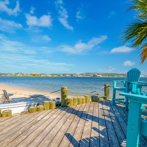 Relax on the deck with stunning water views, palm trees, and comfortable seating just steps from the sandy shore at The Pass