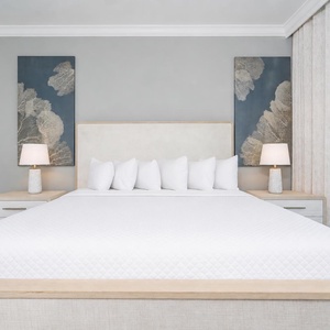 Experience restful nights in this master bedroom with a king bed, soft pillows, and stylish decor