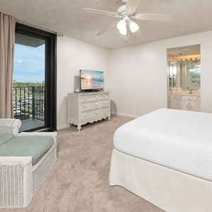 Sink into the king bed and unwind while soaking in views from your balcony in this inviting master bedroom