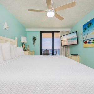 King master suite welcomes you with cool turquoise walls and a balcony offering peaceful beach views