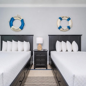 Rest in this inviting room featuring two queen beds, charming decor, and a relaxing vibe for a restful stay