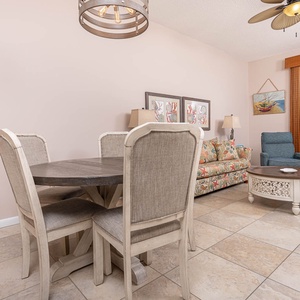 Gather around the round dining table while enjoying the colorful decor and comfortable seating in the inviting living area