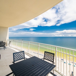 Relax on the balcony with comfortable seating, taking in the expansive views of the tranquil waters and shoreline