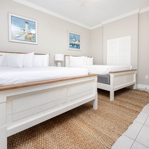 Experience restful nights in this queen guest suite, where plush bedding and coastal decor enhance your relaxation