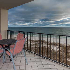 Balcony seating offers a relaxing spot to enjoy sweeping views of the tranquil beach and gentle waves of the gulf