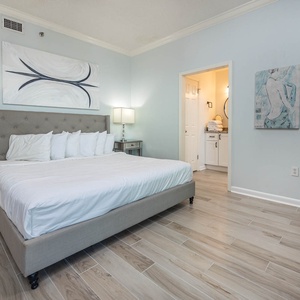 Relax in this serene master bedroom featuring a king bed, stylish decor, and easy access to the adjoining master bath