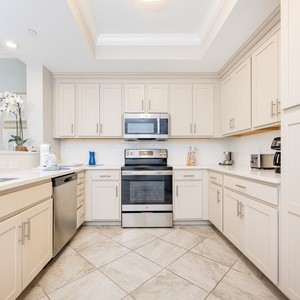 Prepare meals in this kitchen with elegant cabinetry, stainless appliances, and spacious countertops