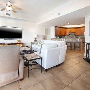 This living area features a large TV and comfortable seating, perfect for relaxing after a day at the beach