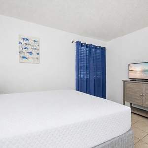 Relax in this queen guest suite, accompanied by calming beach vibes and a favorite movie streaming nearby
