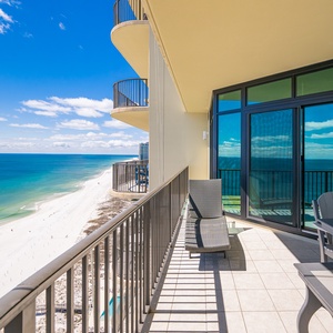 Relax in the lounge chair on your balcony, taking in the stunning views of the beach and coast beyond