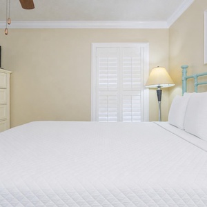 Relax in a cozy guest bedroom, enjoying the soft queen bedding and watching your favorite shows