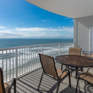 Enjoy a stunning beachfront view from the balcony, complete with a table and chairs for relaxing moments