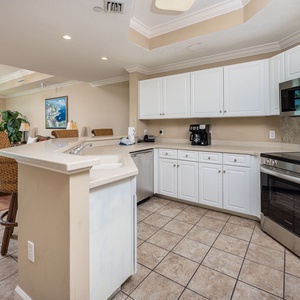 Prepare meals in this kitchen with sleek cabinetry, stainless appliances, and spacious countertops