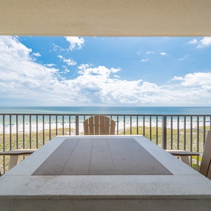 Relax on the balcony with comfortable seating and enjoy the expansive view of the beach and gulf waters