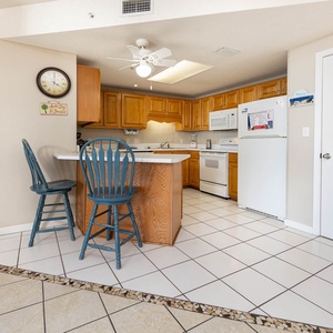 Gather around the breakfast bar, perfect for coffee or casual meals in this inviting kitchen space