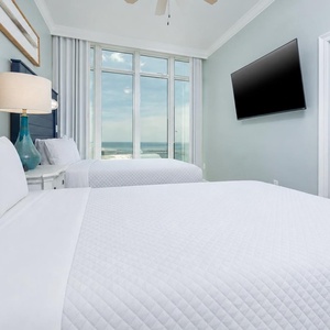 Awaken to a colorful gulf coast sunrise in this queen guest suite and get ready for a beach day