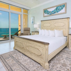 Savor gulf air from the balcony while relaxing in this king master suite with stylish decor