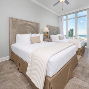 Wake to a breathtaking sunrise in this queen guest suite with two cozy beds and expansive views from the windows