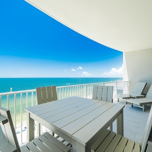Relax at the outdoor dining table, enjoying sweeping views of the tranquil waters and bright blue sky