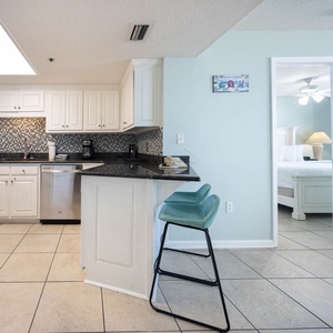 Prepare meals in this kitchen, featuring stainless appliances and a breakfast bar area for casual dining