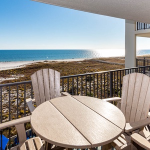 Serene view of the beach and gulf waters from the balcony, perfect for enjoying sunsets and relaxing moments