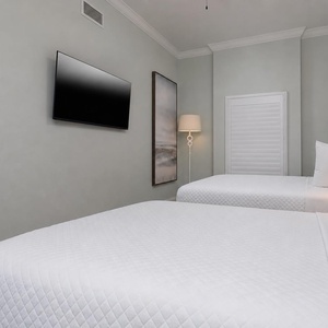 Lie back on soft bedding, play favorites on the TV, and unwind under gentle lamplight in this queen guest suite