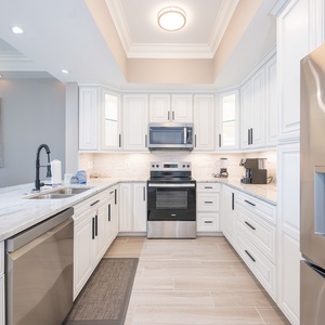 Prepare meals in this kitchen featuring elegant cabinetry, stainless appliances, and a stylish design