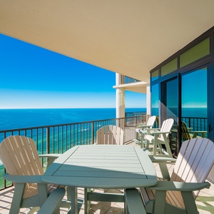 Enjoy beach views from this twenty-second floor balcony, featuring comfortable seating and a dining table for relaxation