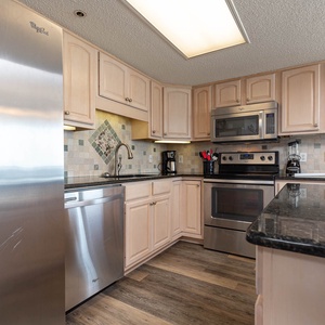 Cook and gather in this inviting kitchen, featuring stainless appliances and elegant cabinetry