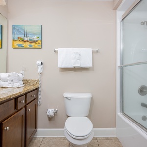 Freshen up in this guest bath in the relaxing shower or soothing tub before an exciting beach day