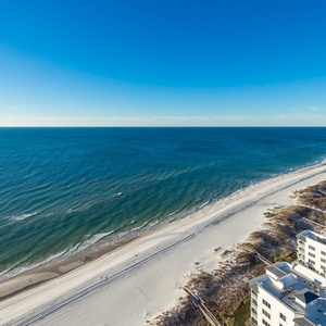 Breathe salt air on the beachfront balcony while sunlight dances on the water toward the horizon