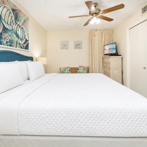Relax in the king suite, enjoying the serene beach vibe while catching up on your favorite shows
