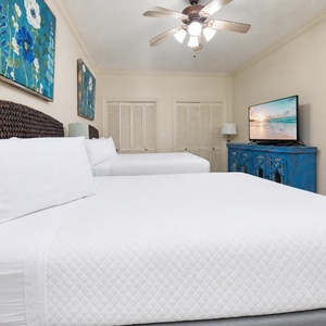 Rest in this inviting guest room with two comfortable queen beds, colorful art, and a TV for entertainment during your stay