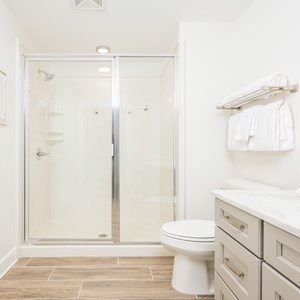 Refreshing guest bath featuring a spacious walk-in shower, soft towels, and a stylish vanity