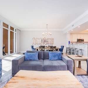 Sunlight pours through floor-to-ceiling windows framing the gulf in this inviting vacation rental