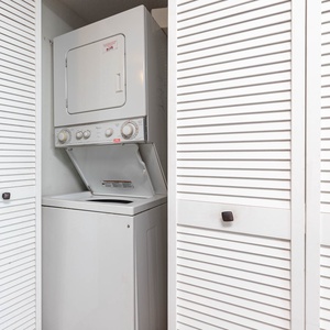 This laundry area features a stacked washer and dryer, providing convenience for guests during their stay
