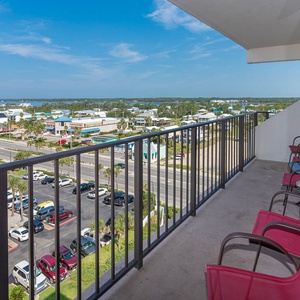 Enjoy a relaxing view from the balcony with seating, overlooking vibrant coastal scenery and nearby attractions