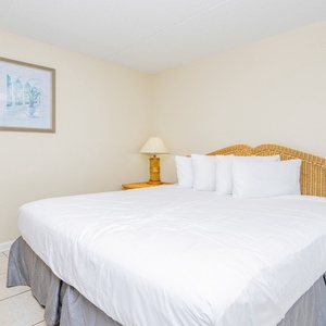 This bedroom features a plush bed with crisp linens, perfect for a restful night's sleep
