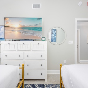 Relax with a movie in this cheerful guest suite with two queen beds and coastal accents