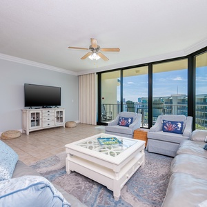 Relax in the spacious living area, featuring a queen sofa sleeper, and enjoy the views through the balcony doors