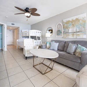 Inviting living area, featuring a sofa with queen sleeper, twin over full bunk bed, stylish decor, and a cozy space