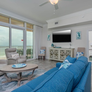 Gather in this welcoming living space and enjoy stunning beach views from the balcony