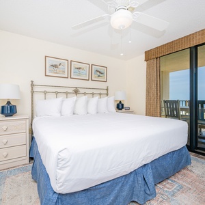 Unwind in this spacious master bedroom featuring a king bed, coastal decor, and beachfront balcony access