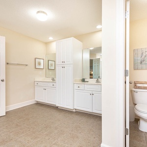 Experience the master bath featuring dual sinks, ample storage, and a calming decor for your daily routine