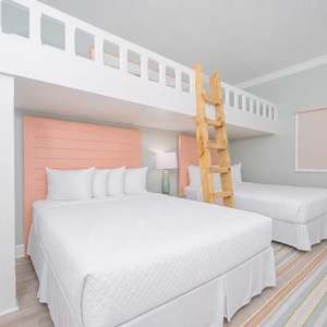 Sleep comfortably in this bunk room featuring two queen beds below and a playful loft with two twin beds above